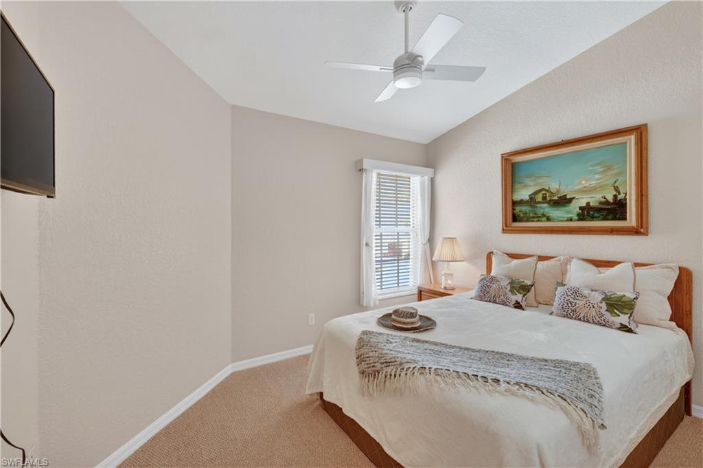 13061 Hamilton Harbour Drive, Unit R5 Naples, FL 34110 - Photo 27 of 39 a bedroom with a bed and a window