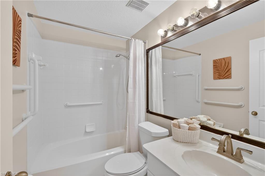 13061 Hamilton Harbour Drive, Unit R5 Naples, FL 34110 - Photo 29 of 39 a bathroom with a sink toilet and shower