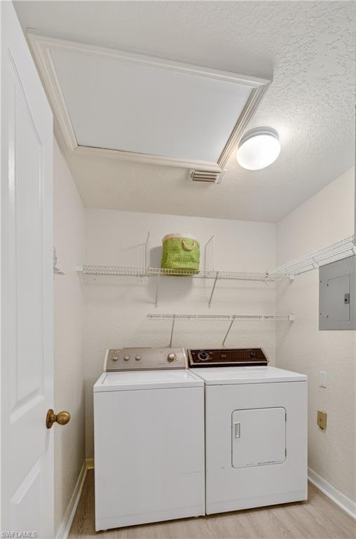 13061 Hamilton Harbour Drive, Unit R5 Naples, FL 34110 - Photo 30 of 39 a utility room with cabinets washer and dryer