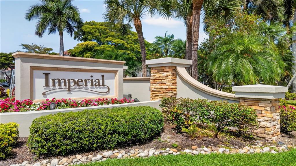 13061 Hamilton Harbour Drive, Unit R5 Naples, FL 34110 - Photo 3 of 39 a sign that is sitting in front of flowers