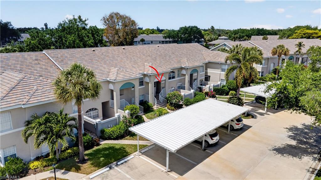 13061 Hamilton Harbour Drive, Unit R5 Naples, FL 34110 - Photo 31 of 39 an aerial view of a house with balcony and outdoor space