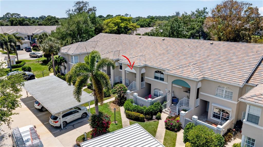 13061 Hamilton Harbour Drive, Unit R5 Naples, FL 34110 - Photo 32 of 39 an aerial view of a house roof deck and outdoor seating
