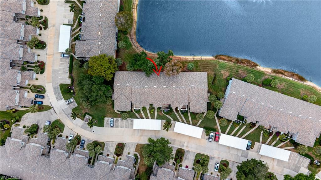 13061 Hamilton Harbour Drive, Unit R5 Naples, FL 34110 - Photo 39 of 39 an aerial view of a house with a yard and lake view