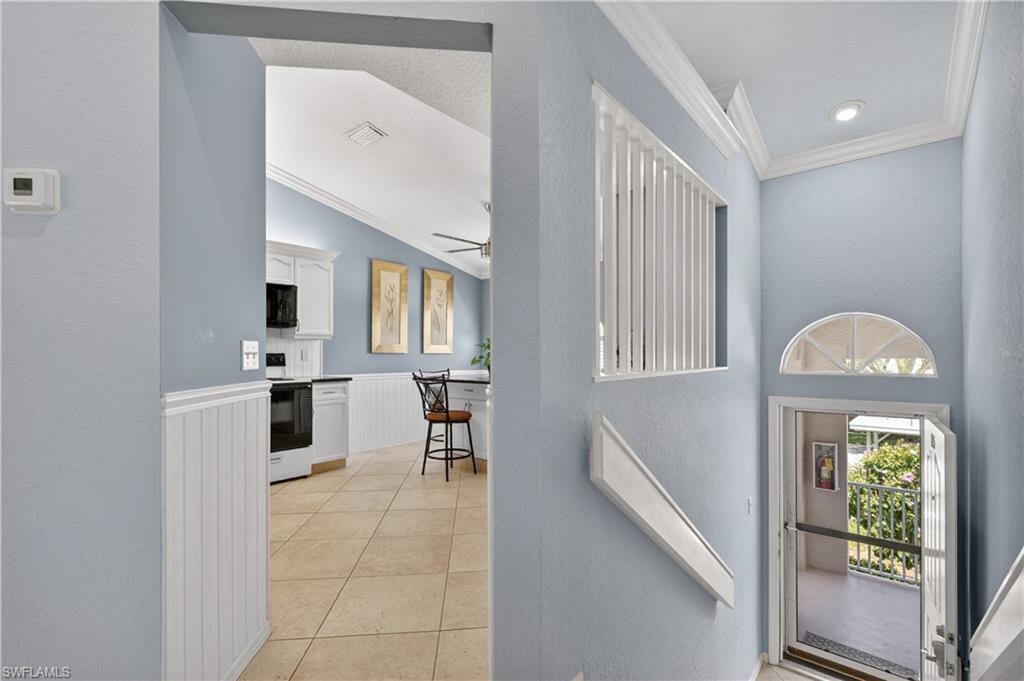 13061 Hamilton Harbour Drive, Unit R5 Naples, FL 34110 - Photo 6 of 39 a view of a hallway with kitchen and entryway