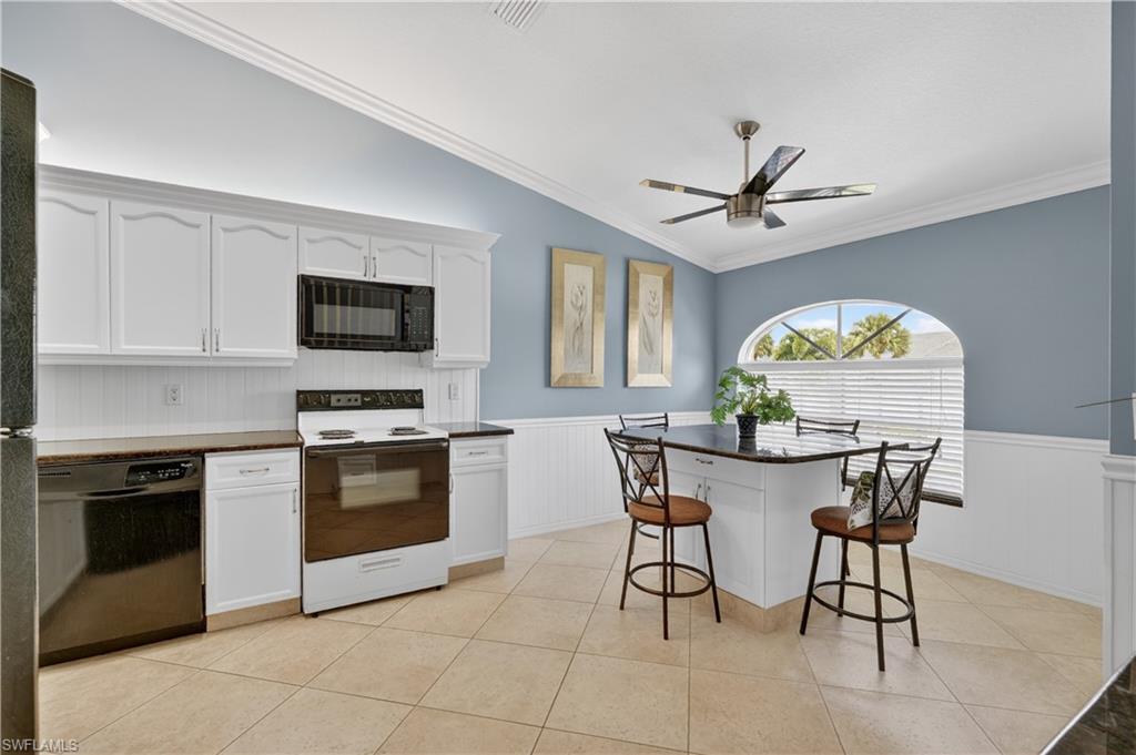 13061 Hamilton Harbour Drive, Unit R5 Naples, FL 34110 - Photo 9 of 39 a view of a kitchen with a dining table and a stove top oven