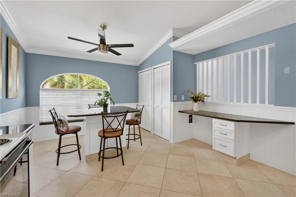 13061 Hamilton Harbour Drive, Unit R5 Naples, FL 34110 - Photo 10 of 39 a kitchen with stainless steel appliances a counter space a sink cabinets and window