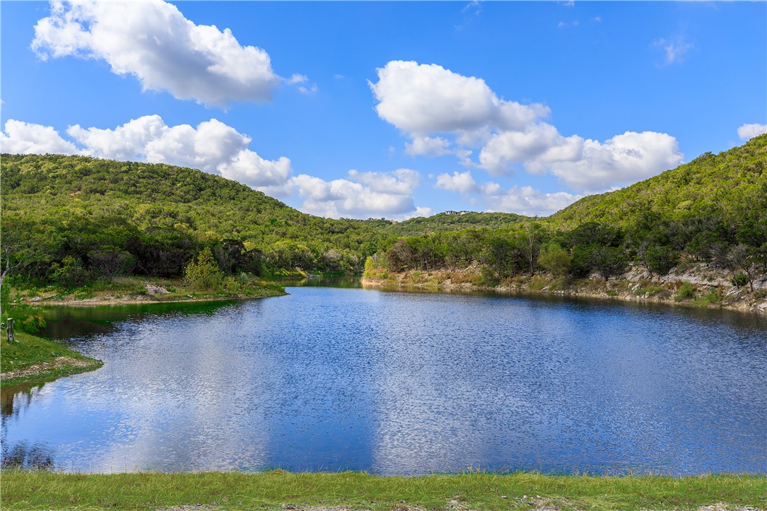 a view of a lake with houses in the back