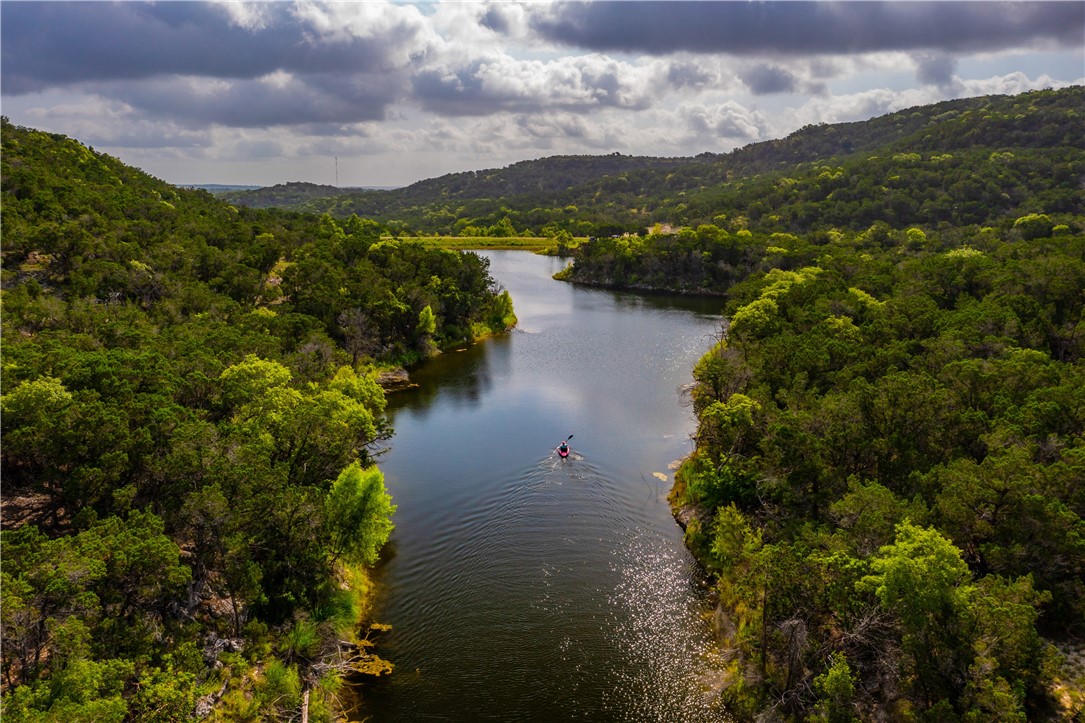 0 Brushy Ridge Trail Blanco, TX 78606 - Photo 24 of 27 a view of a lake with mountains in the background