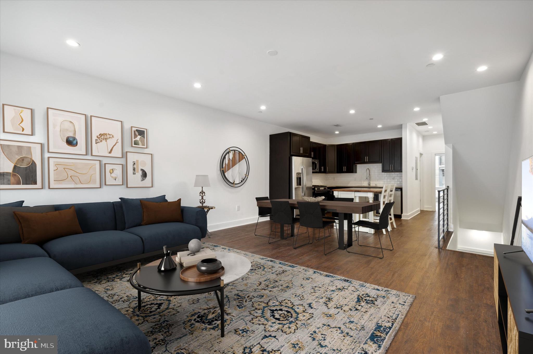 a living room with furniture kitchen view and a table