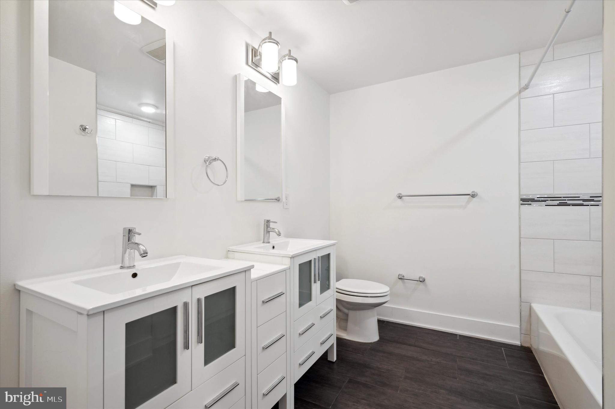 1219 North 5th Street, Unit 2 Philadelphia, PA 19122 - Photo 12 of 16 a bathroom with a double vanity sink mirror and toilet