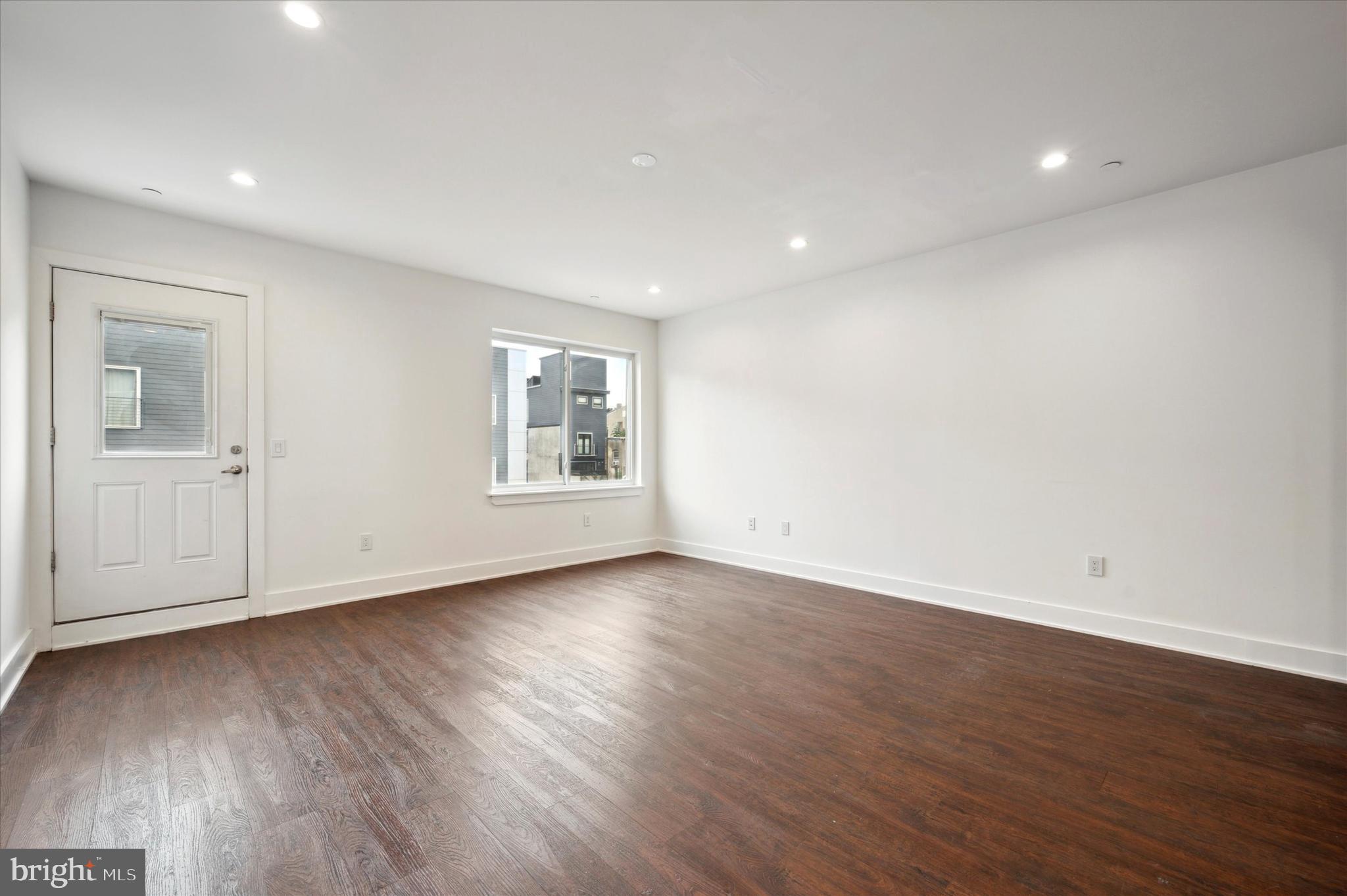 1219 North 5th Street, Unit 2 Philadelphia, PA 19122 - Photo 8 of 16 an empty room with wooden floor and windows