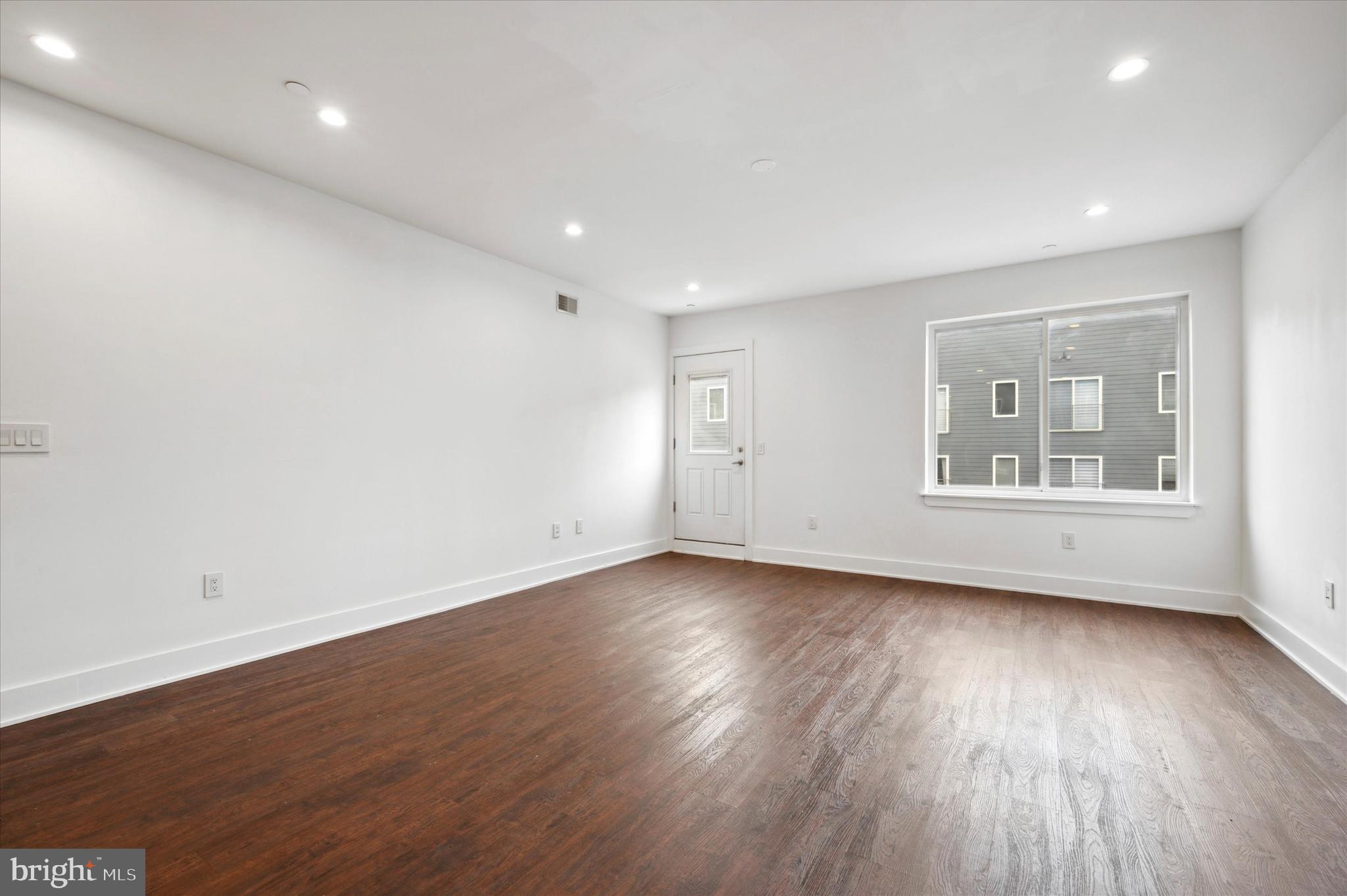 1219 North 5th Street, Unit 2 Philadelphia, PA 19122 - Photo 9 of 16 an empty room with wooden floor and windows