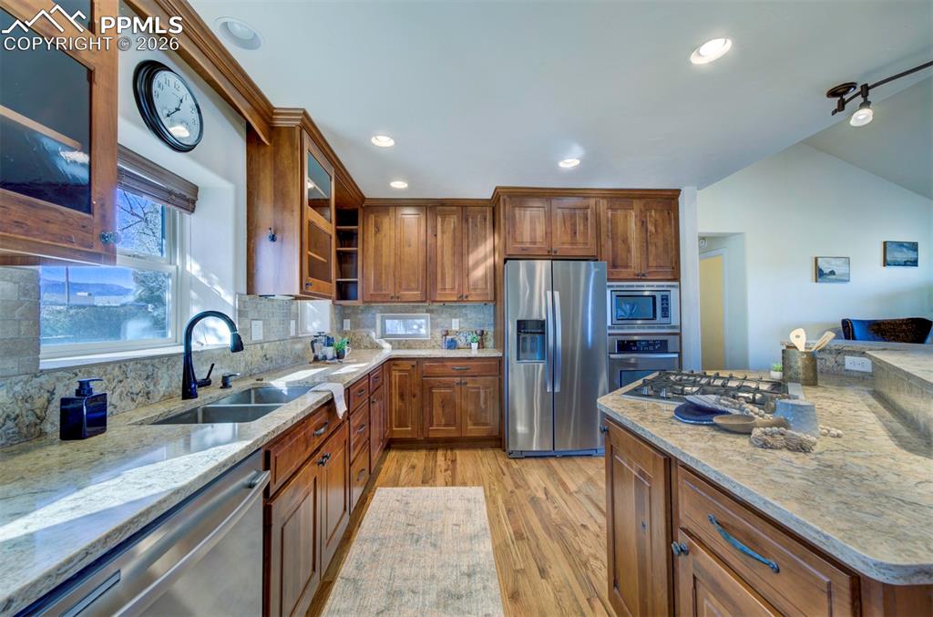 1905 Mesa Road Colorado Springs, CO 80904 - Photo 14 of 44 a kitchen with stainless steel appliances granite countertop a sink stove and refrigerator