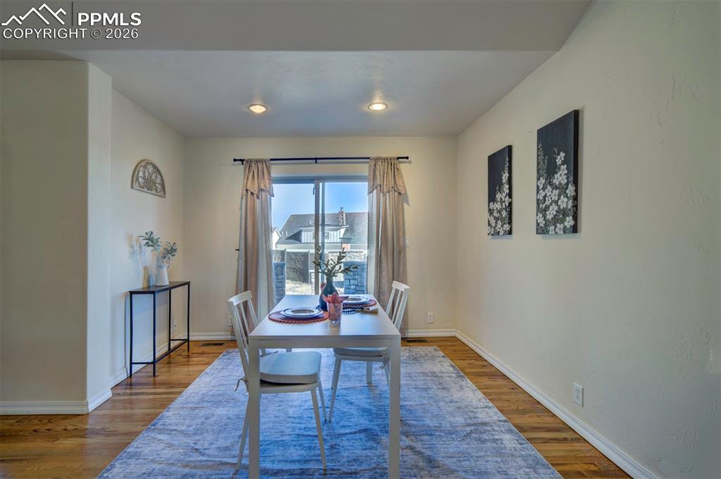 1905 Mesa Road Colorado Springs, CO 80904 - Photo 15 of 44 a dining room with wooden floor and a rug