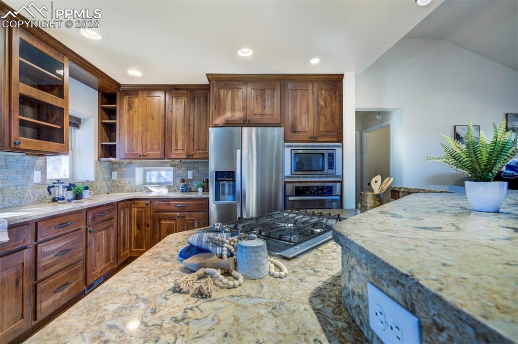 1905 Mesa Road Colorado Springs, CO 80904 - Photo 16 of 44 a kitchen with stainless steel appliances granite countertop sink stove refrigerator and cabinets