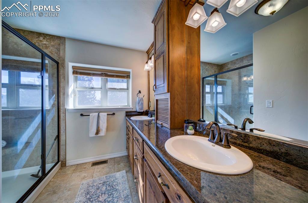 1905 Mesa Road Colorado Springs, CO 80904 - Photo 22 of 44 a bathroom with a double vanity sink and a mirror