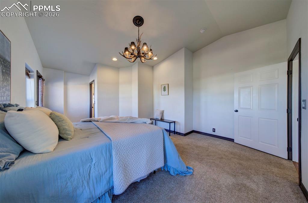 1905 Mesa Road Colorado Springs, CO 80904 - Photo 25 of 44 a spacious bedroom with a bed and a chandelier