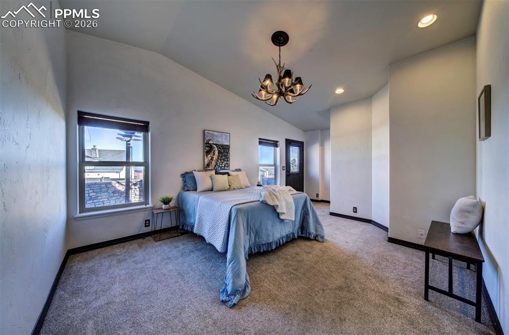 1905 Mesa Road Colorado Springs, CO 80904 - Photo 26 of 44 a spacious bedroom with a bed and a chandelier