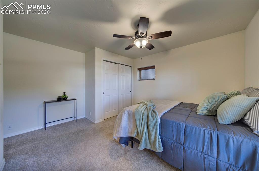 1905 Mesa Road Colorado Springs, CO 80904 - Photo 28 of 44 a bedroom with a bed and a chandelier