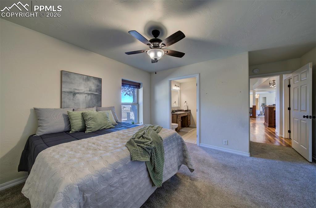 1905 Mesa Road Colorado Springs, CO 80904 - Photo 29 of 44 a bedroom with a large bed and a chandelier