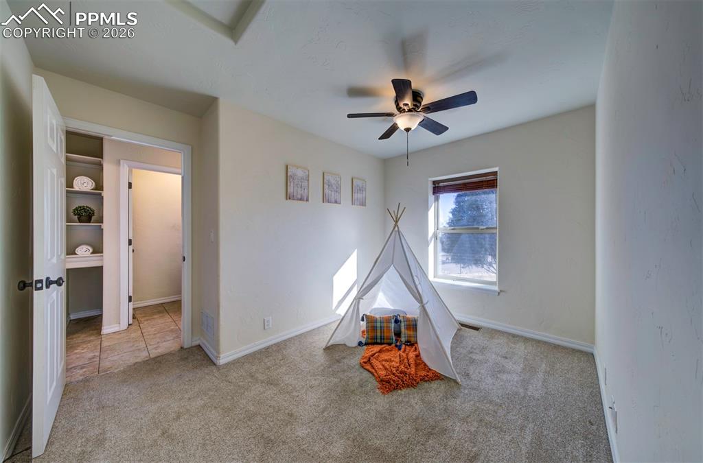 1905 Mesa Road Colorado Springs, CO 80904 - Photo 31 of 44 a view of a room with wooden floor ceiling fan and windows