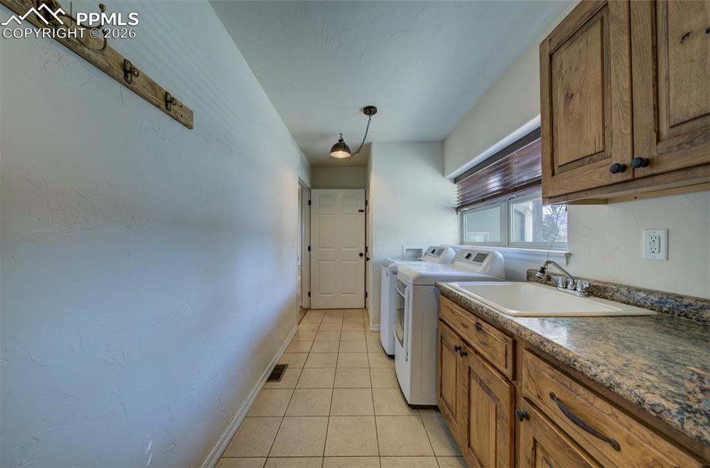 1905 Mesa Road Colorado Springs, CO 80904 - Photo 35 of 44 a kitchen with granite countertop a sink stove and cabinets