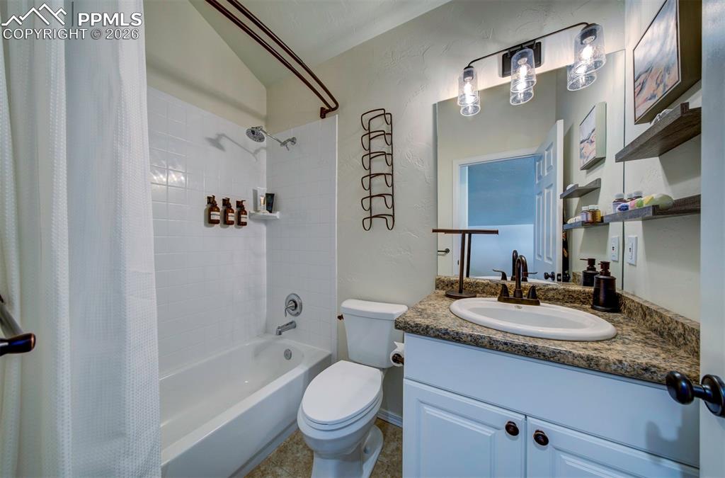 1905 Mesa Road Colorado Springs, CO 80904 - Photo 40 of 44 a bathroom with a granite countertop sink toilet and shower