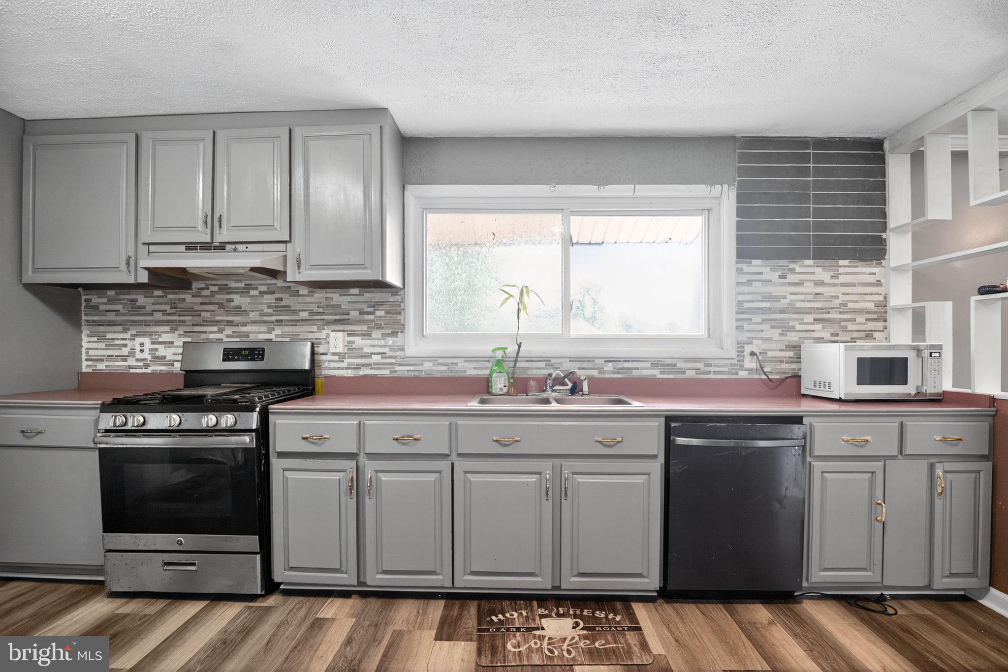 11 La Gorce Boulevard Burlington, NJ 08016 - Photo 11 of 22 a kitchen with a stove sink and cabinets