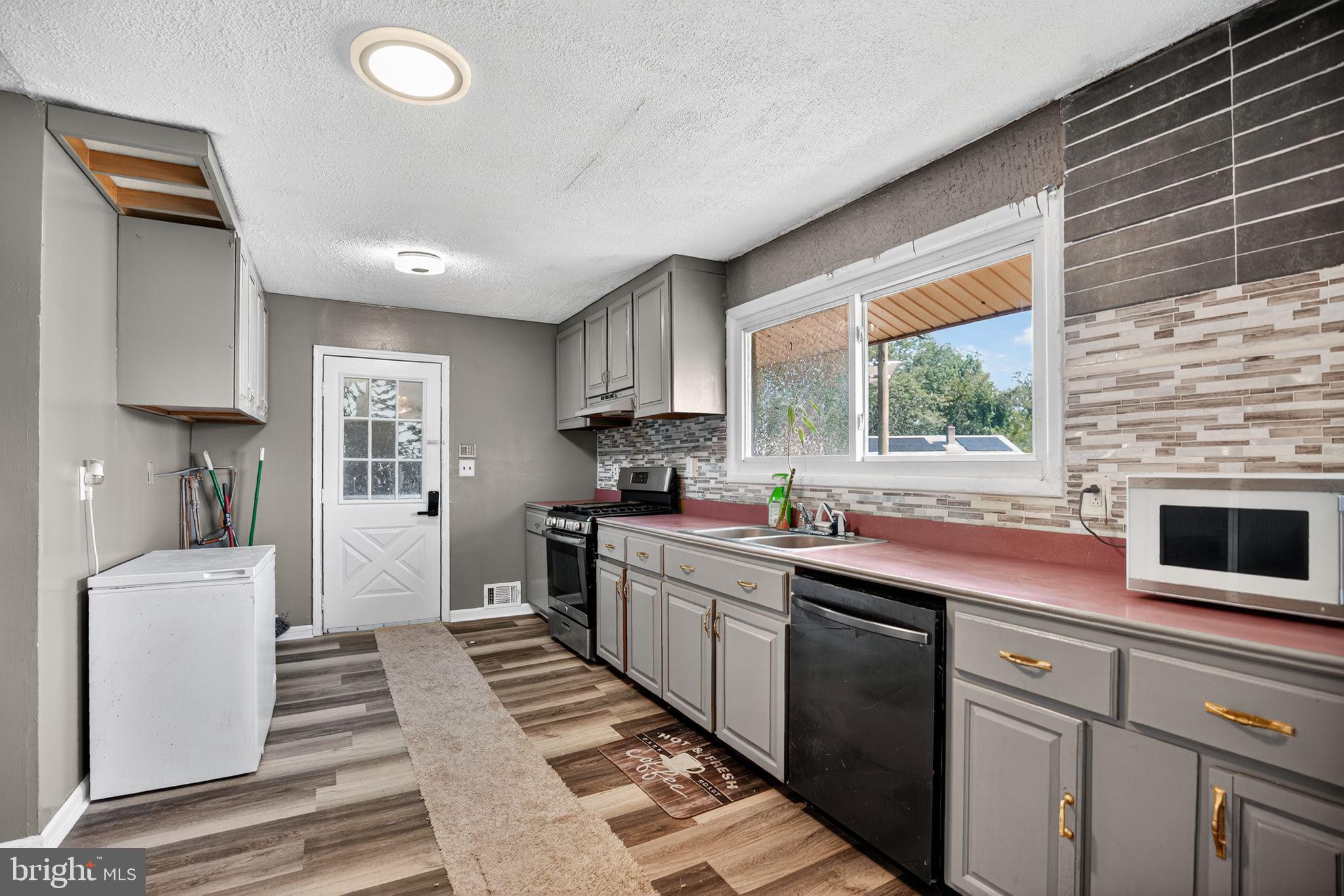 11 La Gorce Boulevard Burlington, NJ 08016 - Photo 14 of 22 a kitchen with stainless steel appliances a sink stove and cabinets