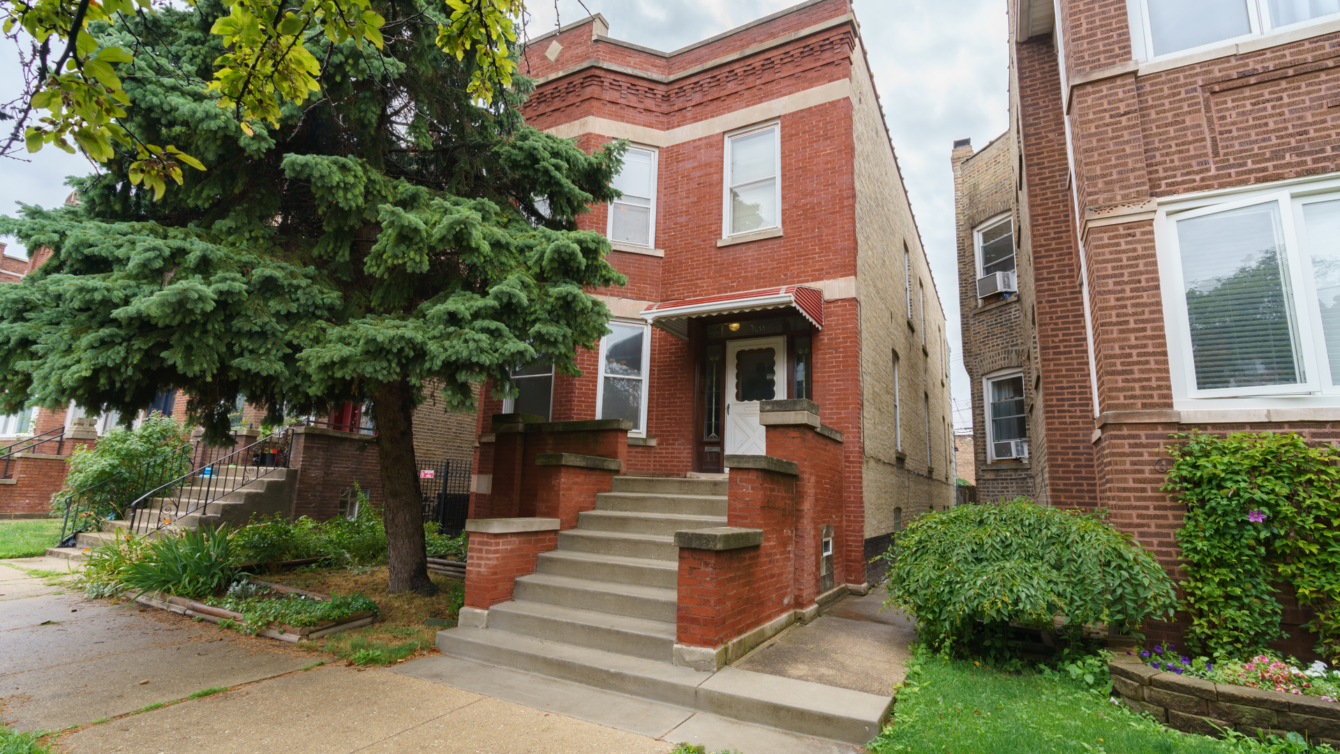 2644 North Harding Avenue Chicago, IL 60647 - Photo 1 of 37 a front view of a house with plants and trees