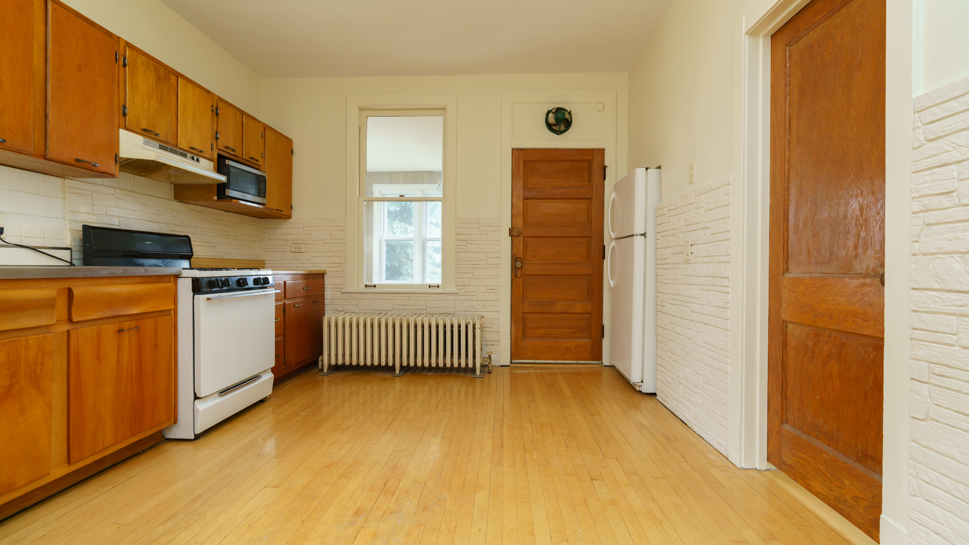 2644 North Harding Avenue Chicago, IL 60647 - Photo 20 of 37 a view of a kitchen with stainless steel appliances wooden floor and cabinets