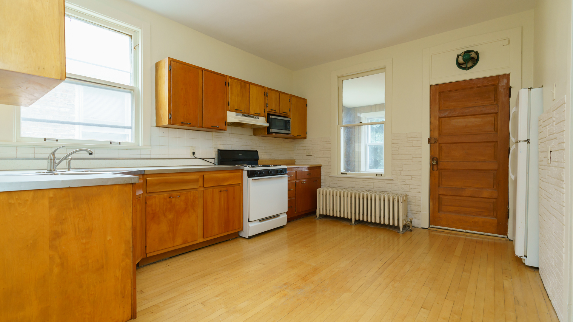 2644 North Harding Avenue Chicago, IL 60647 - Photo 22 of 37 a kitchen with a sink cabinets and window