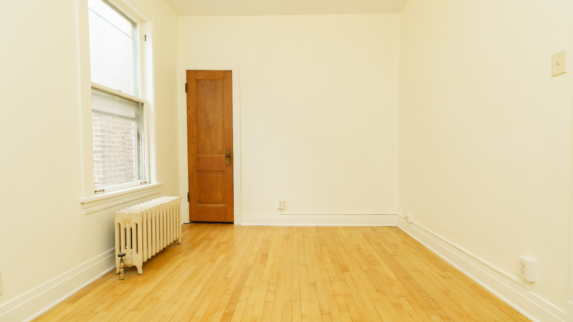 2644 North Harding Avenue Chicago, IL 60647 - Photo 26 of 37 a view of an empty room with wooden floor and a window
