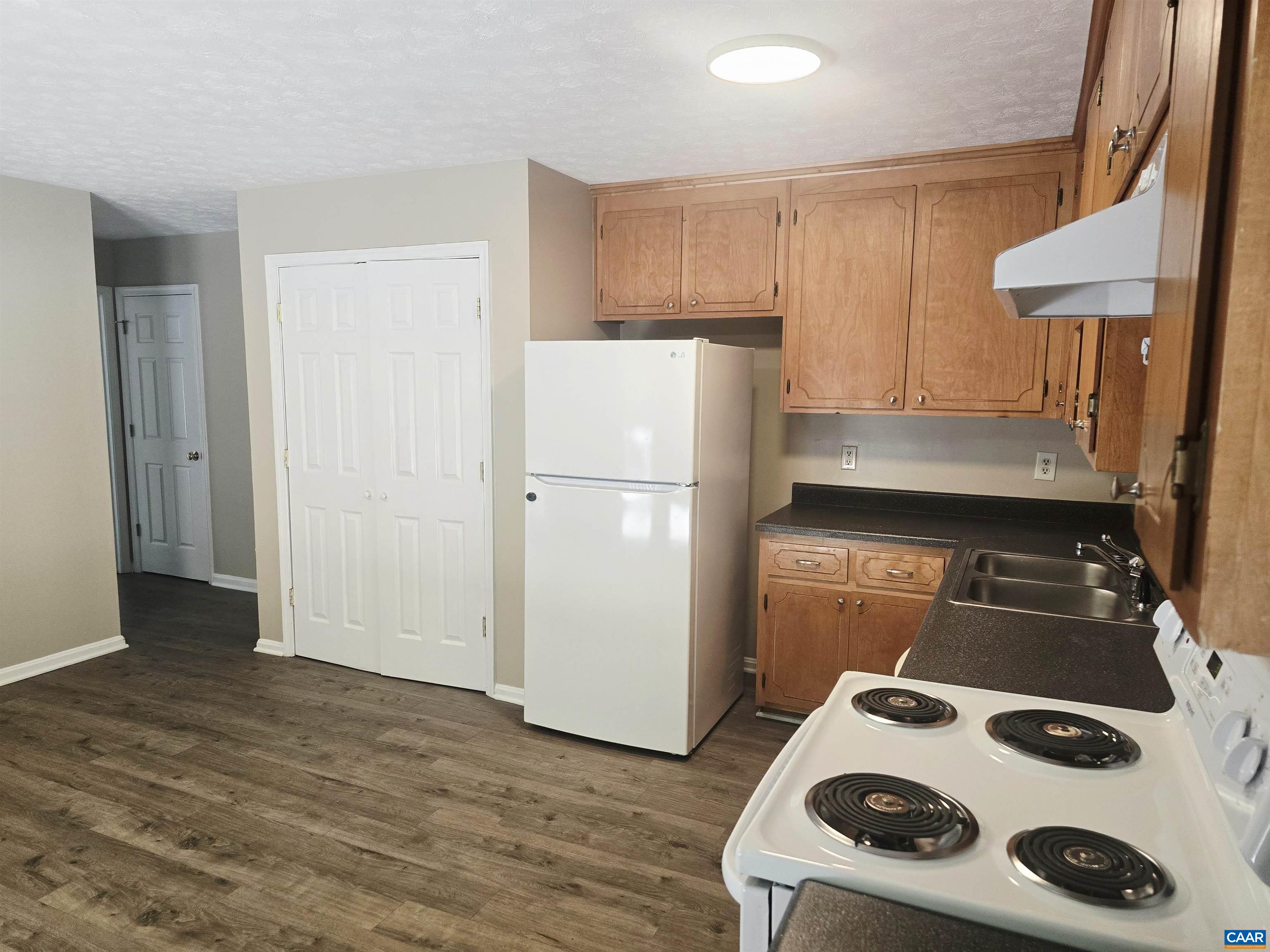 79 Haney Road Ruckersville, VA 22968 - Photo 9 of 15 a kitchen with a refrigerator and a stove