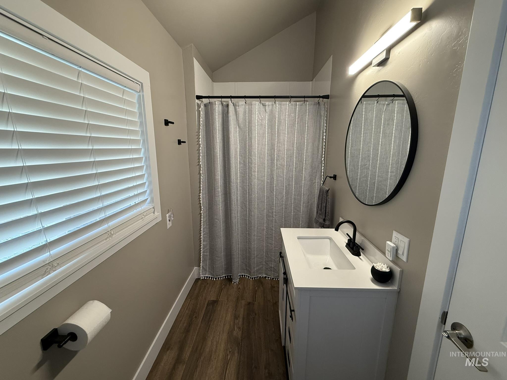 532 Old Pollock Road Riggins, ID 83549 - Photo 18 of 25 Full bathroom featuring curtained shower, vanity, vaulted ceiling, and dark wood-style flooring