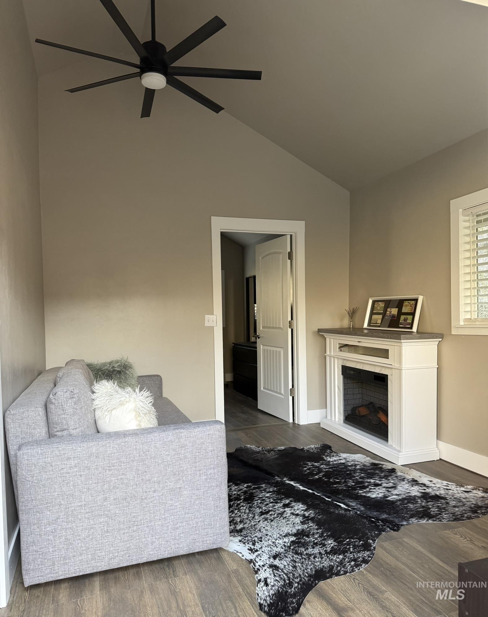 532 Old Pollock Road Riggins, ID 83549 - Photo 20 of 25 Living room featuring vaulted ceiling, wood finished floors, ceiling fan, and a fireplace