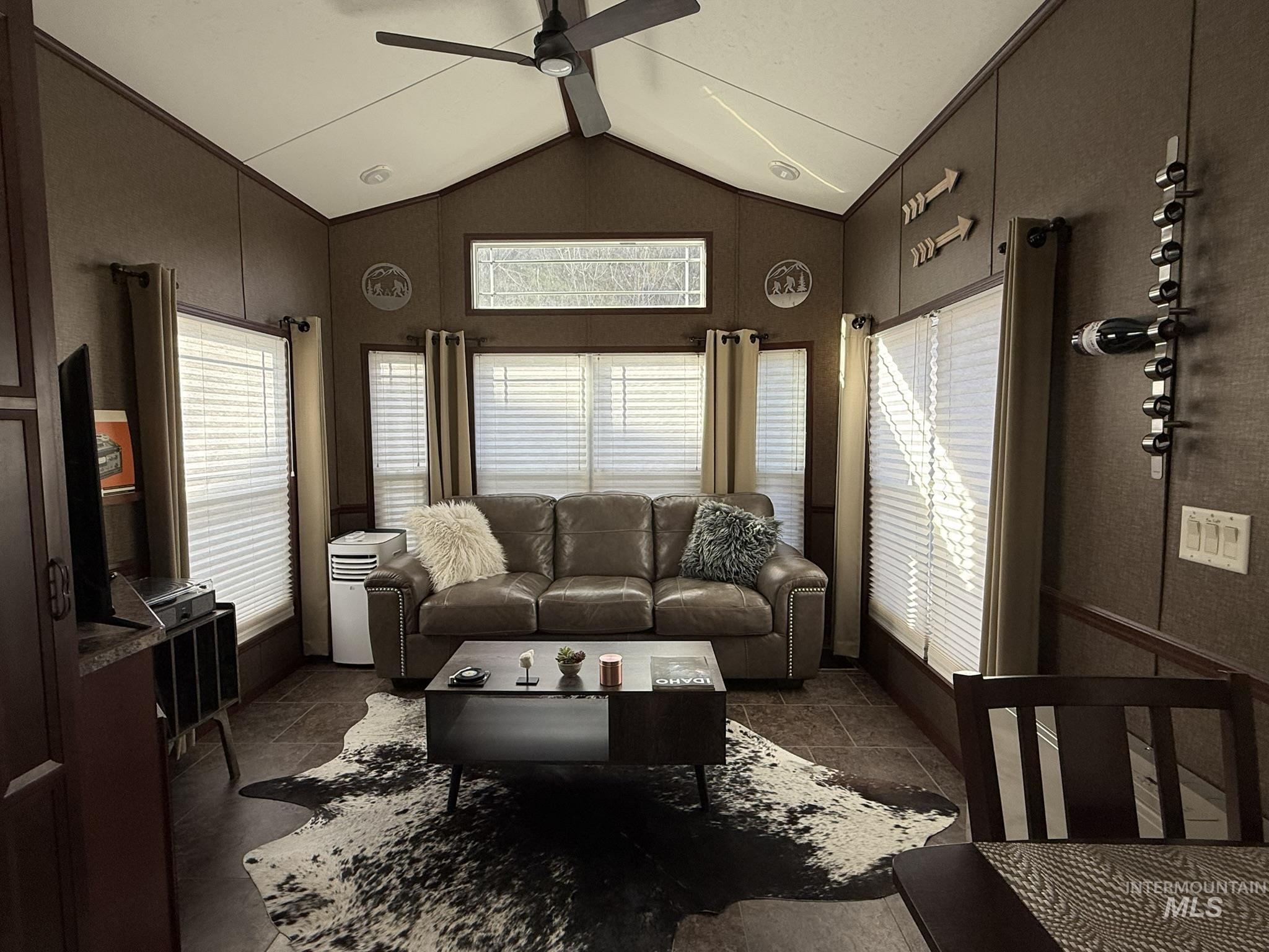 532 Old Pollock Road Riggins, ID 83549 - Photo 6 of 25 Living room featuring stone tile floors and a ceiling fan
