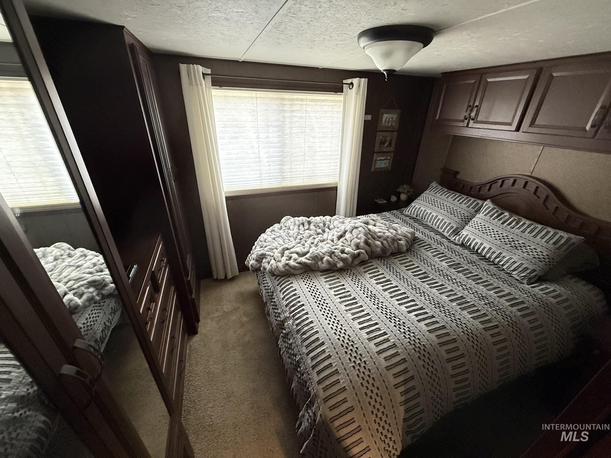 532 Old Pollock Road Riggins, ID 83549 - Photo 7 of 25 Carpeted bedroom featuring a textured ceiling