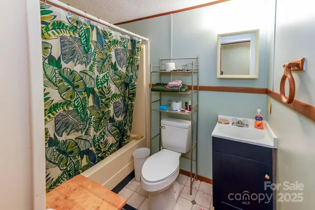 a white toilet sitting next to a bathroom sink and a window