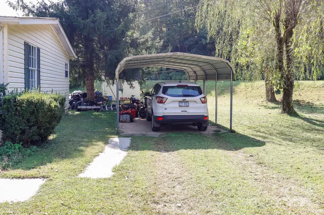 a view of a house with backyard and sitting area