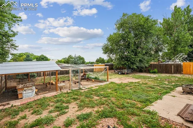 a view of a patio with table and chairs under an umbrella