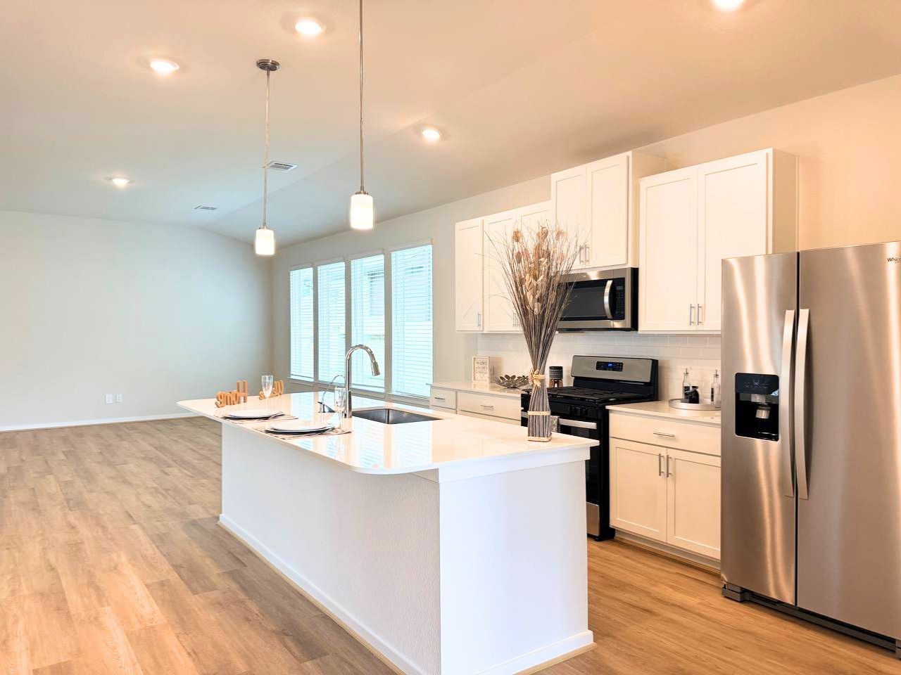16246 Parish Pointe Court Conroe, TX 77302 - Photo 14 of 32 a kitchen with a sink a counter top space stainless steel appliances and cabinets