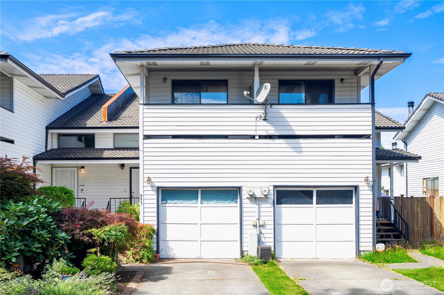 4217 Northeast 5th Street Renton, WA 98059 - Photo 1 of 24 a view of a house with a yard and garage