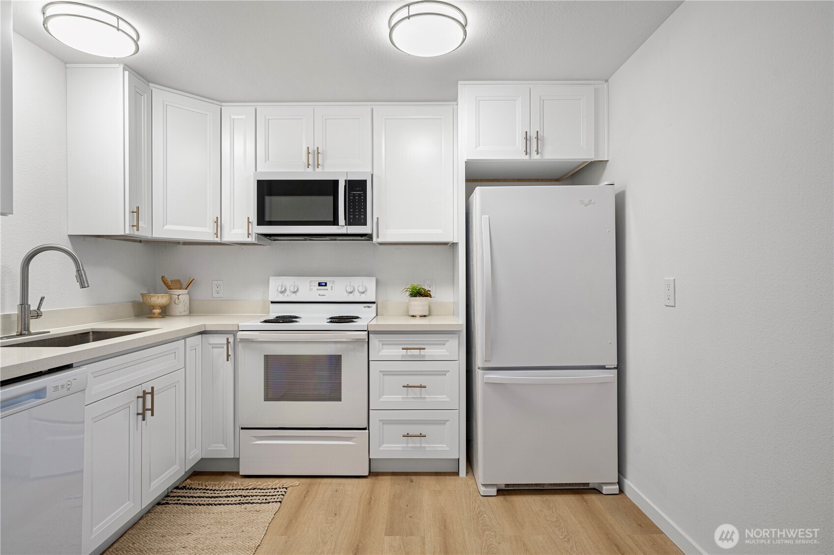 4217 Northeast 5th Street Renton, WA 98059 - Photo 5 of 24 a kitchen with white cabinets and white appliances