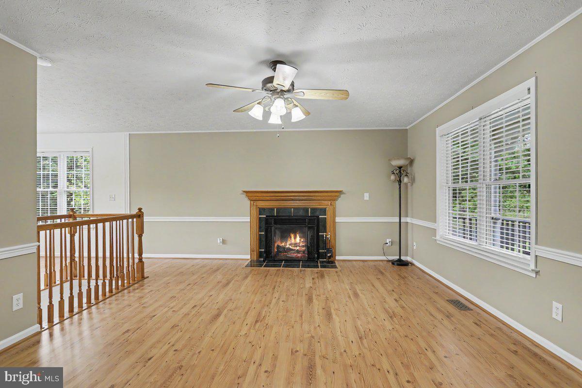 543 Whiskey Still Road Linden, VA 22642 - Photo 7 of 23 a view of an empty room with a window and wooden floor