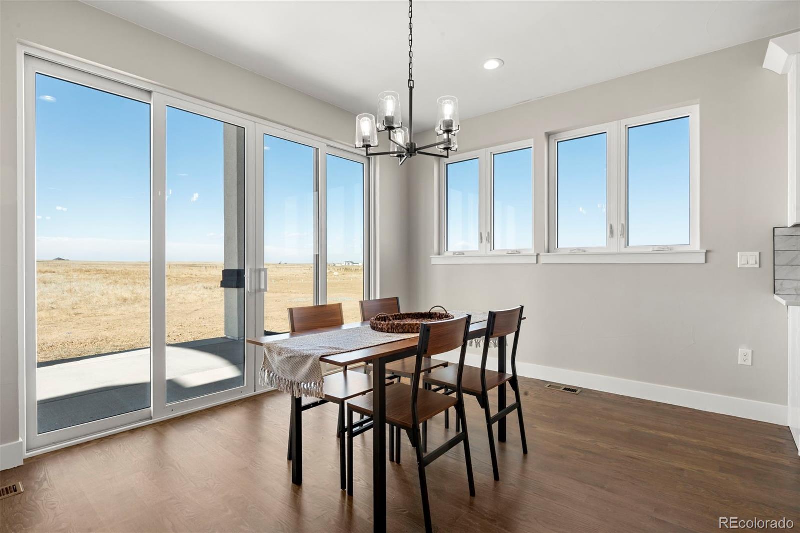 12450 Imboden Road Hudson, CO 80642 - Photo 13 of 46 a view of a dining room with furniture window and wooden floor