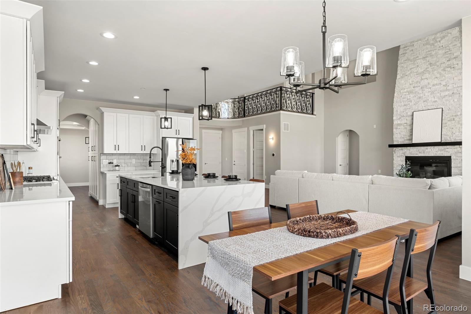 12450 Imboden Road Hudson, CO 80642 - Photo 14 of 46 a kitchen with kitchen island a stove a table and chairs in it