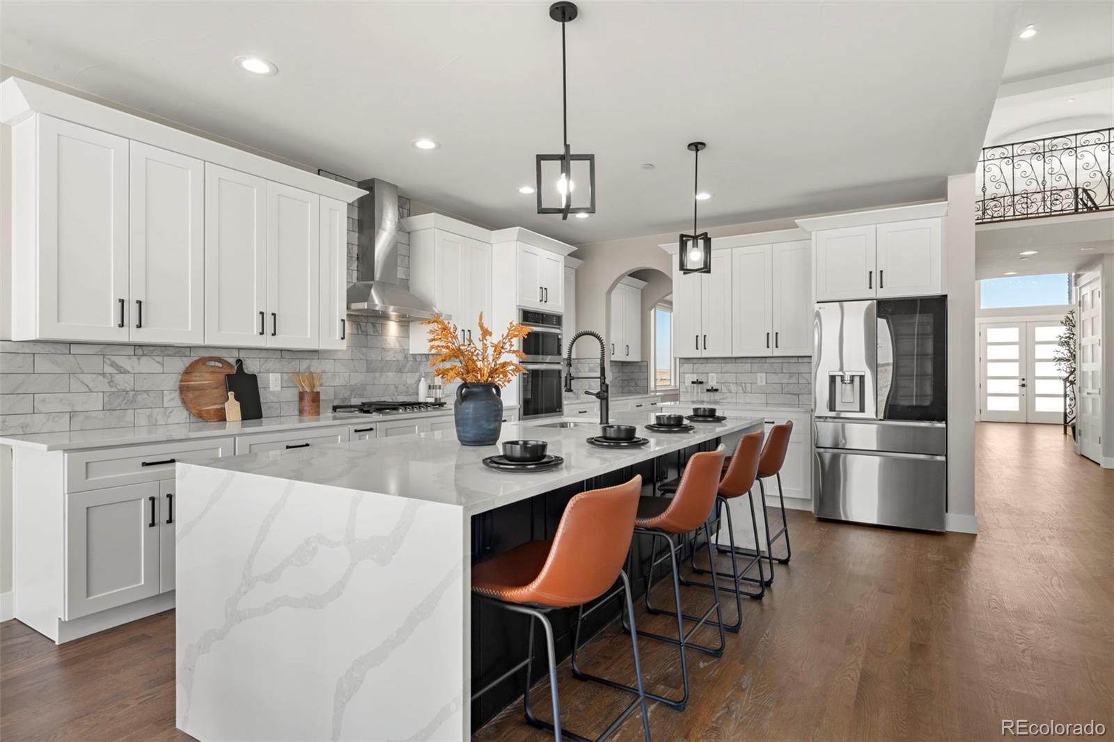 12450 Imboden Road Hudson, CO 80642 - Photo 10 of 46 a large kitchen with granite countertop lots of white cabinets stainless steel appliances