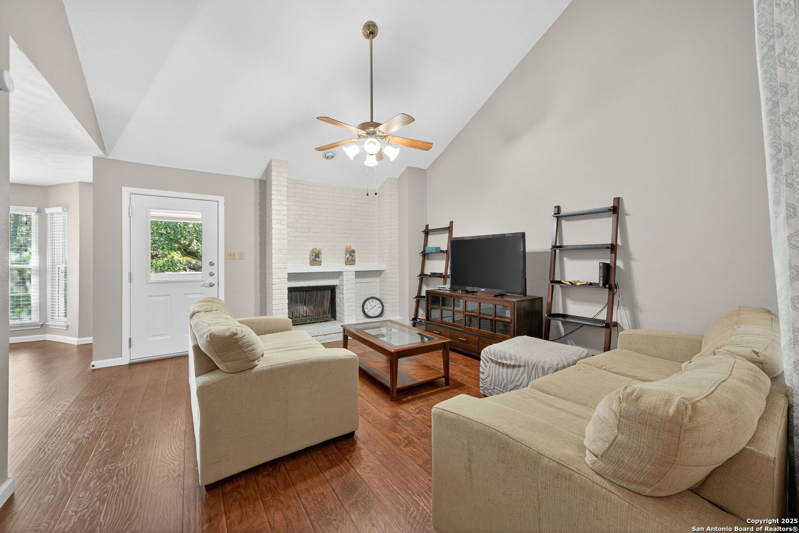 13130 Blanco Road, Unit 206 San Antonio, TX 78216 - Photo 1 of 12 a living room with furniture a fireplace and a flat screen tv
