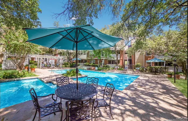 a view of a backyard with sitting area and furniture